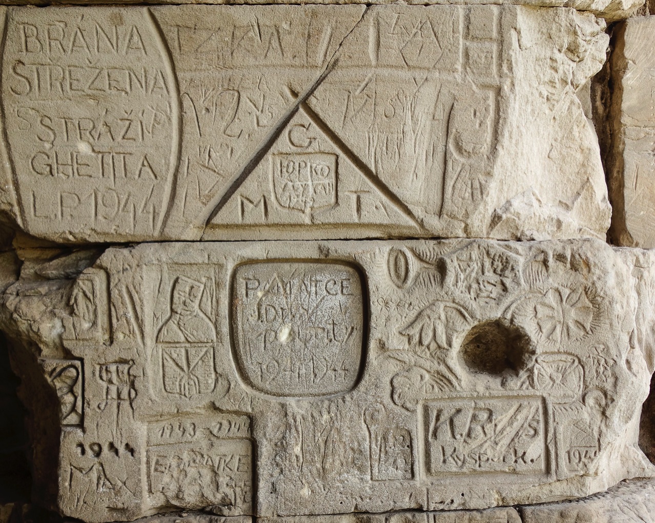 Carvings in upper portion of the south wall of moat tunnel at Terezin