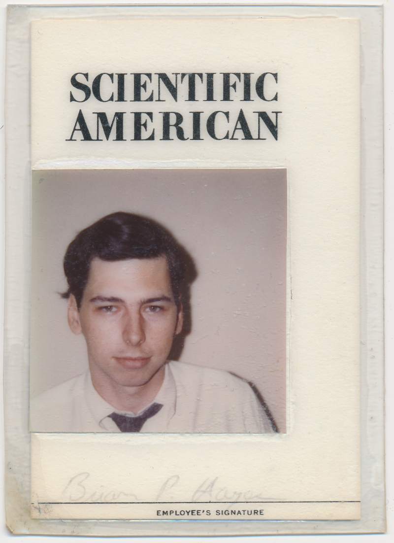 A wallet-size ID badge showing my face on the cover of an issue of Scientific American magazine. I'm 23 years old and still have a lot of dark hair.